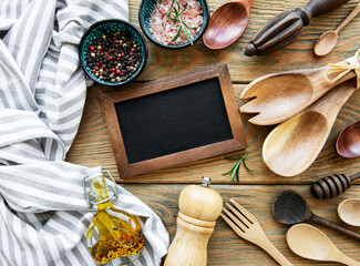 Empty chalk board and kitchen utensils
