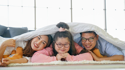Down syndrome Happy family parents go to bed at the same time