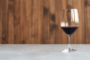 Horizontal side view on a glass of red wine on the table