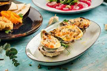 Gourmet baked julienne served in an oyster shell on blue background