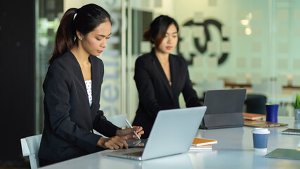 Businesswomen meeting on their project in modern meeting room