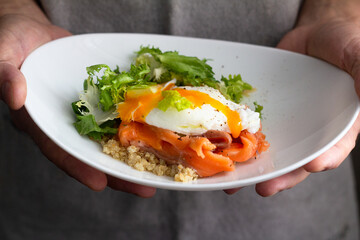 quinoa with fish and egg for breakfast close-up
