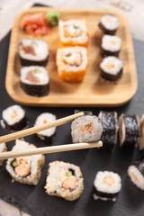 roll sushi caught with chopsticks