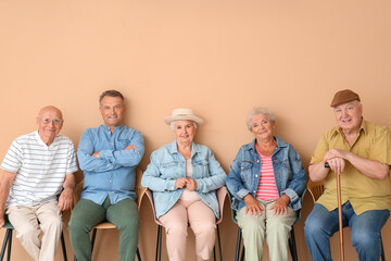 Senior people sitting on chairs in room