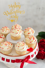 Vanilla muffins or cupcakes with heart sprinkles. St. Valentines day baking. Selective focus, close up. Romantic dinner recipe. Bakery, confectionery