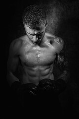 Fototapeta na wymiar Portrait of young attractive shirtless muscular male boxer with defined abs