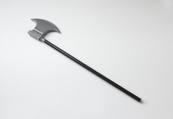 Plastic miniature model of pick axe with black handle. Toy ax isolated white background. 