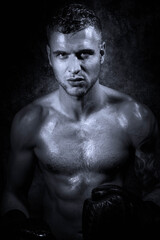 Portrait of young attractive shirtless muscular male boxer with defined abs