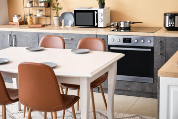 Dinning table in interior of modern kitchen