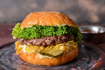 Tray with tasty burger on table