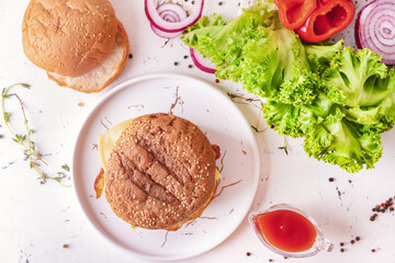 Tray with tasty burger on light background