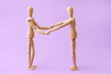 Wooden mannequins on color background. Concept of support