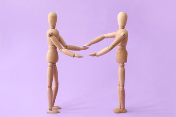 Wooden mannequins on color background. Concept of support