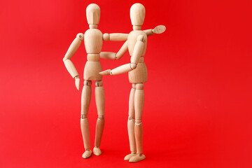 Wooden mannequins on color background. Concept of support