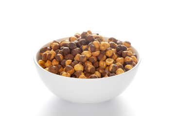Crunchy Roasted Chana Masala in a white bowl, made with Bengal Grams or Chickpeas. Pile of Indian spicy snacks (Namkeen). Side view, against the white background