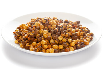 Crunchy Roasted Chana Masala in a white plate, made with Bengal Grams or Chickpeas. Pile of Indian spicy snacks (Namkeen). Side view, against the white background