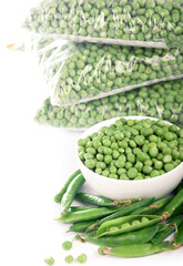 green peas cooked for freezing on a white