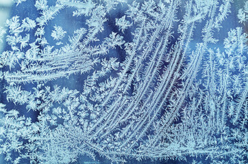 snow patterns on the glass on a blue background