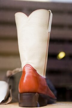 Two-toned cowboy boot in window of a boot shop, Austin, Texas, USA