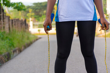 close up of a lady's hands holding a jump rope, ready for exercise