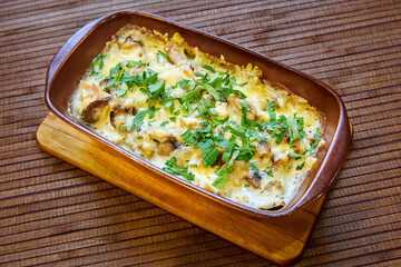 Baked meat with mushrooms and cheese. Al forno. Close-up, selective focus