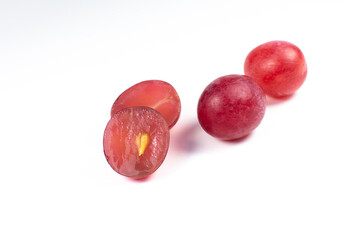 Purple ripe grapes cut in half on the white background. Close up photo. Ecological fruit for vegans. Vitamins.