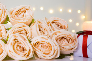 Close up of beige rose bouquet in bokeh light background.