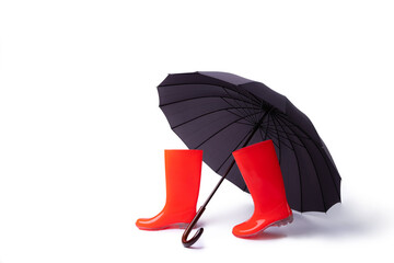 Rubber shoes and umbrella isolated on white background. Rain season and weather forecast. Nobody