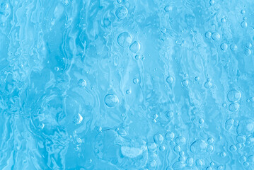 blue transparent clean drinking water abstract background. water surface with air bubbles background