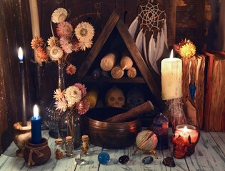 Burning candles, Tibetan singing bowl and crystals on the witch table.