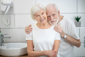 Elderly couple in the bathroom looking happy and smiling