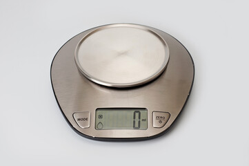 Scales kitchen desktop metal electronic with a metal bowl. Background for household appliances.