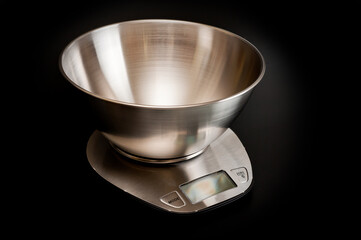 Scales kitchen desktop metal electronic with a metal bowl. Background for household appliances.