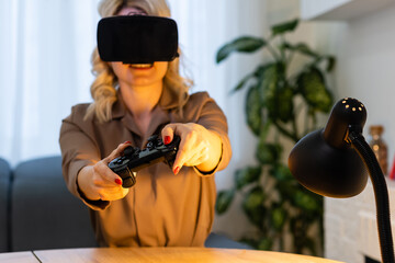 Portrait of woman wearing VR headset playing in shooter game