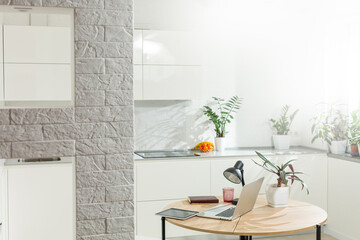 laptop on wood table in modern kitchen room.