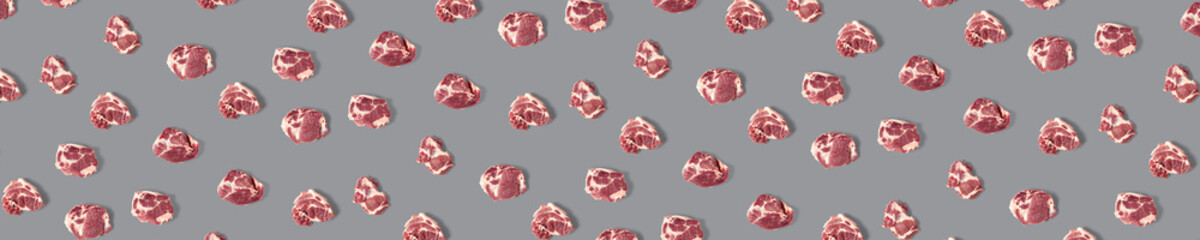 background with raw pork meat slices on grey background, raw food background, not pattern, banner wide shoot