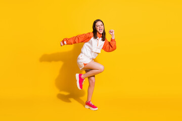 Fototapeta na wymiar Photo portrait full body view of crazy dancing woman screaming isolated on vivid yellow colored background