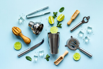 Bartender equipment and cocktail ingredietns - shaker, lime and ice. Overhead view