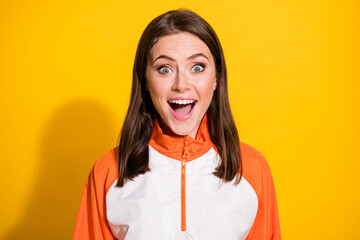Photo of amazed attractive happy young woman unexpected information news isolated on shine yellow...