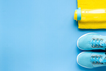 Flat lay of fitness gym equipment with sneakers and bottle of water