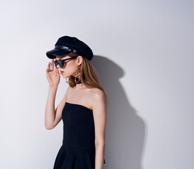 Woman in black dress dark glasses studio luxury light background