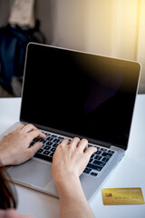 Consumer woman hand using laptop for online shopping according to discount products from home and spending pay via credit card