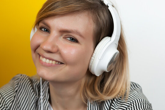 young beautiful girl in big white headphones,
  listen with headphones