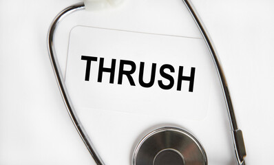 On the card the text of THRUSH, around lies a stethoscope.