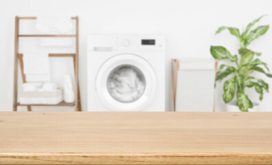 Empty wooden board over blurred laundry room washing machine background