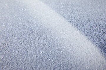 Icy texture on car hood in winter