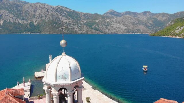 St. George and Gospa od Skrpela islands near town Perast in Montenegro. Flying around the cross. Drone footage.