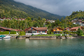 Fototapeta na wymiar Wood chalets at the shores of lake Brienz. Interlaken, Switzerland.