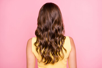 Fototapeta premium Back rear spine view photo of young lady with beautiful perfect long wavy silky glossy hair isolated on pink color background