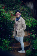 portrait of asian woman smiling face and standing in green park